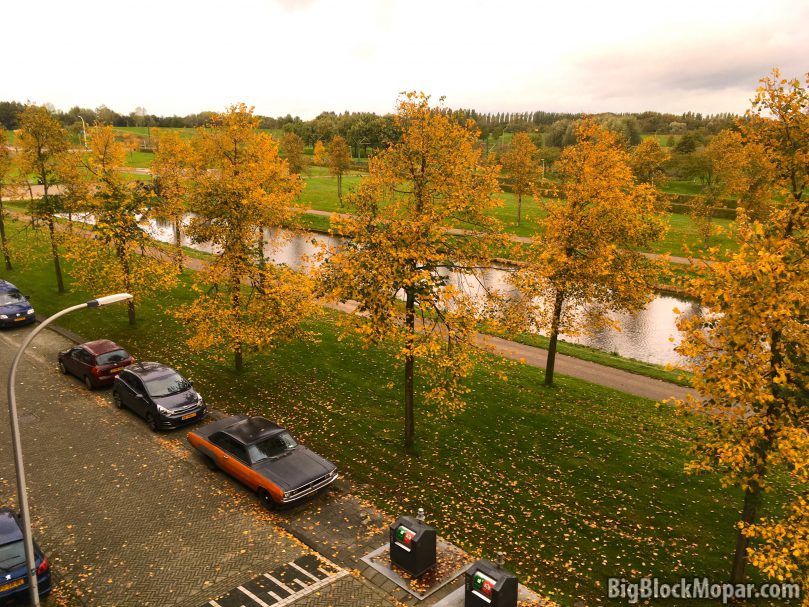 Street with row of trees in autumn colors with a parked 1973 Dodge Dart below